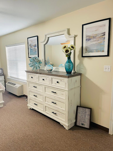 A stylish dresser with a mirror and decorative elements, enhancing the interior of a cozy living space.