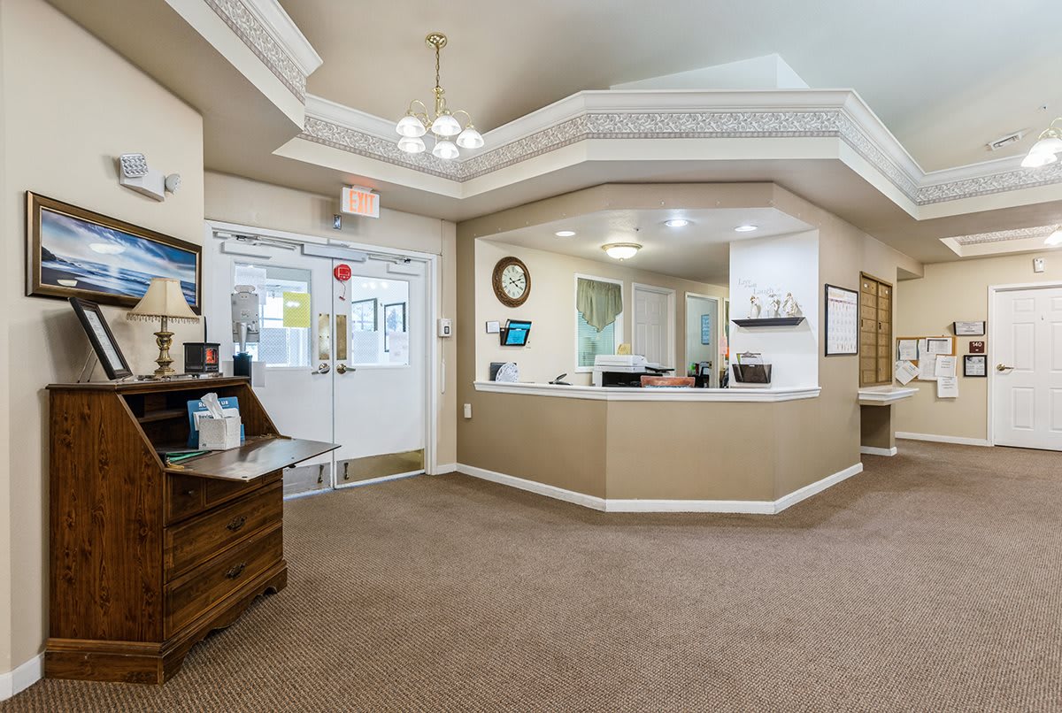A spacious and well-lit reception area with a central desk and waiting space.