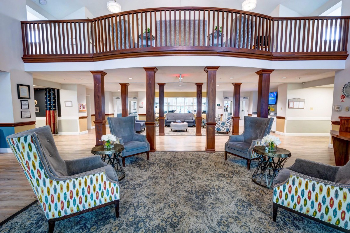 Spacious and elegantly furnished lobby with seating area and balcony.