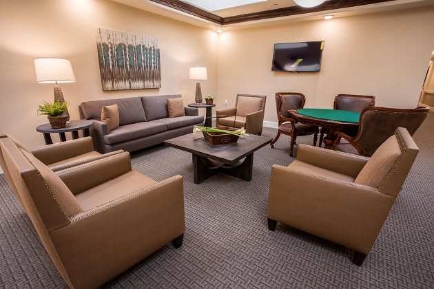 A cozy living room with a modern sofa, armchairs, and a coffee table.