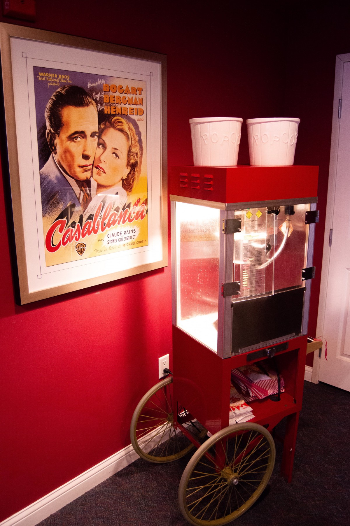 Home theater corner with a popcorn machine and Casablanca movie poster.