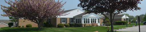 A charming residential house with a well-maintained lawn and garden.