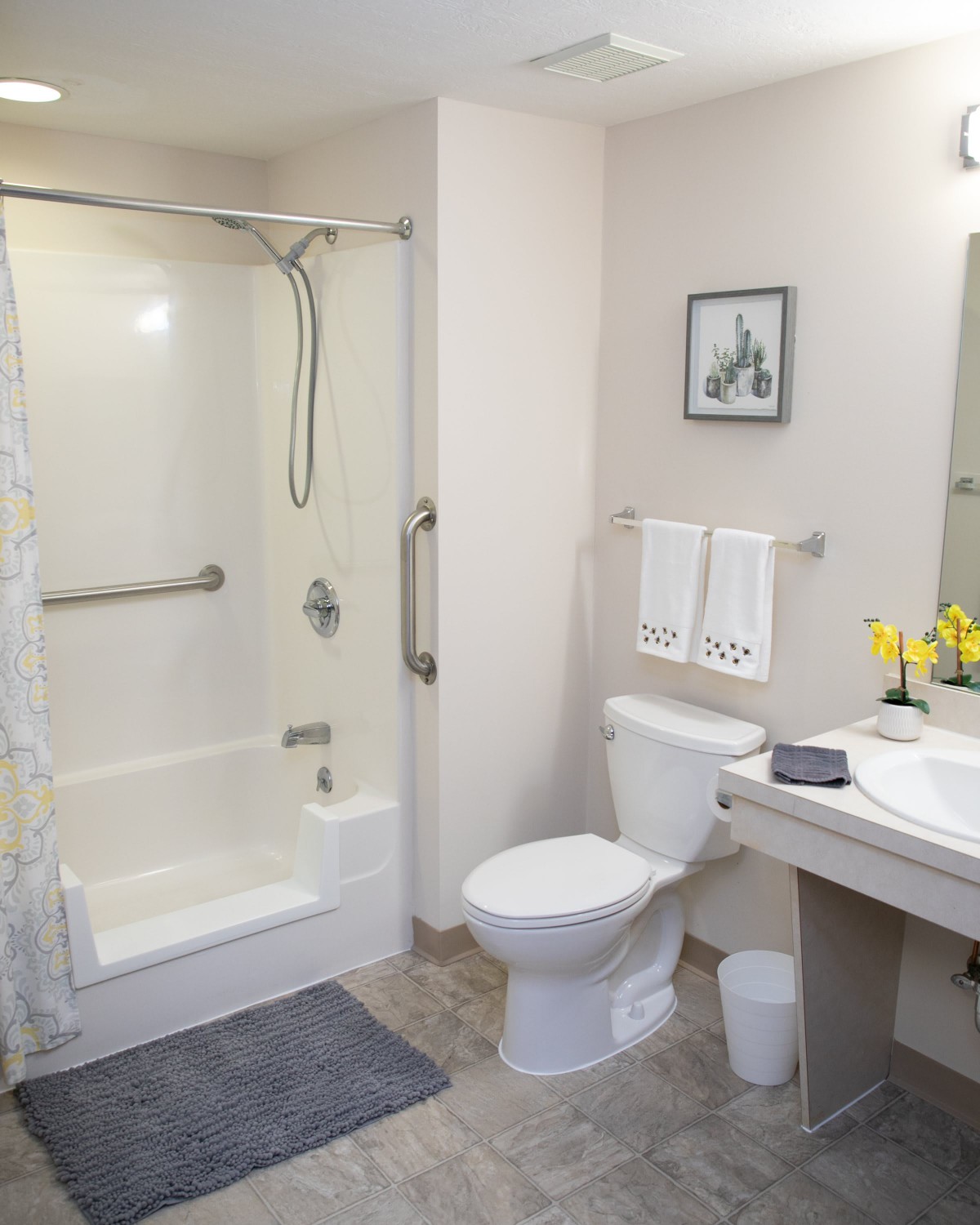 A clean and modern bathroom featuring a shower, toilet, and sink.