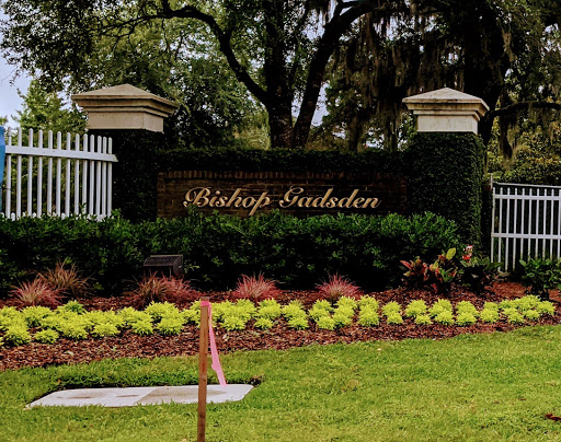 The elegant entrance to Bishop's Garden, adorned with vibrant landscaping.