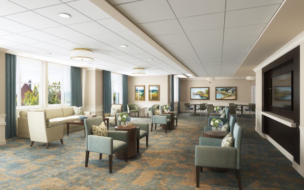 A spacious, well-lit lobby with comfortable seating and decorative artwork on the walls.