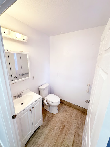 A clean and minimalistic bathroom design featuring essential amenities.
