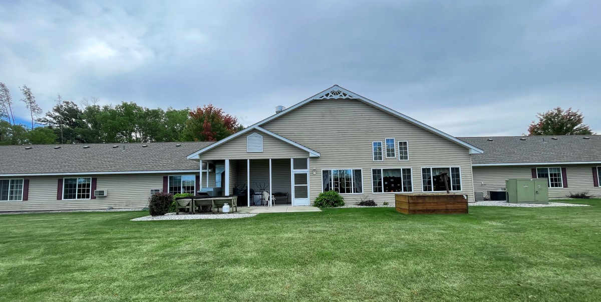 A suburban house with a well-maintained lawn and spacious backyard.