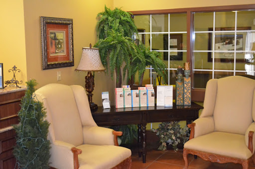 A cozy waiting area featuring comfortable chairs, indoor plants, and a welcoming ambiance.