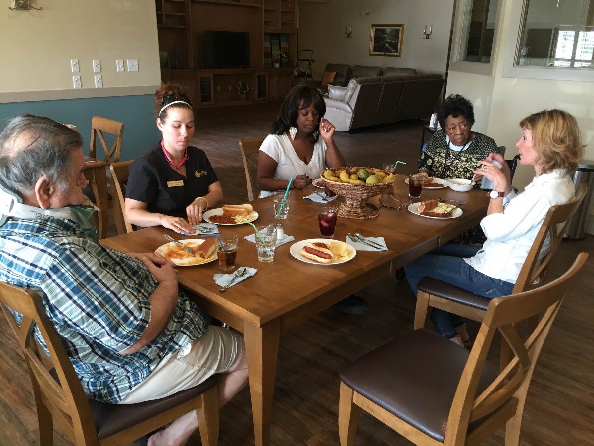 A group of people enjoying a meal together at a dining table.