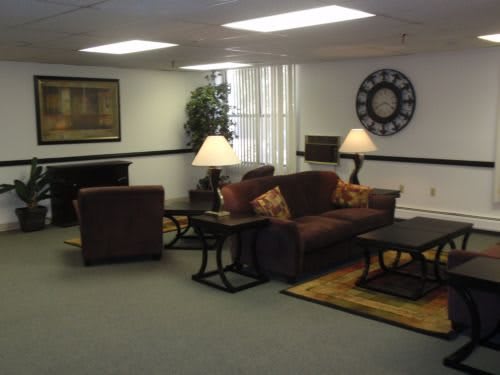 A cozy living room with a sofa set, lamps, and decorative items.