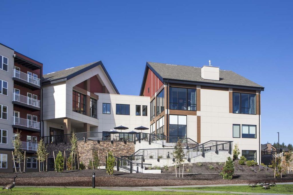 A modern residential building under a clear blue sky.