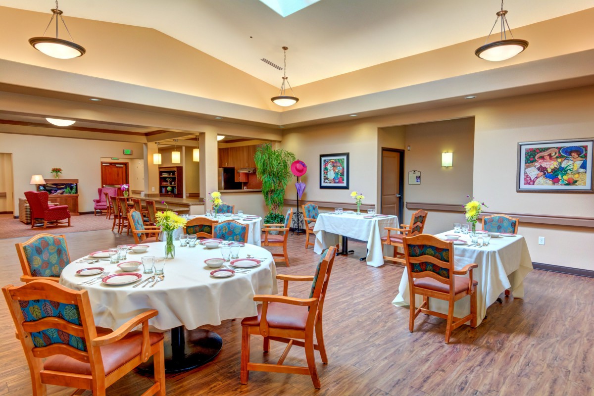 A well-decorated dining area with set tables and chairs.