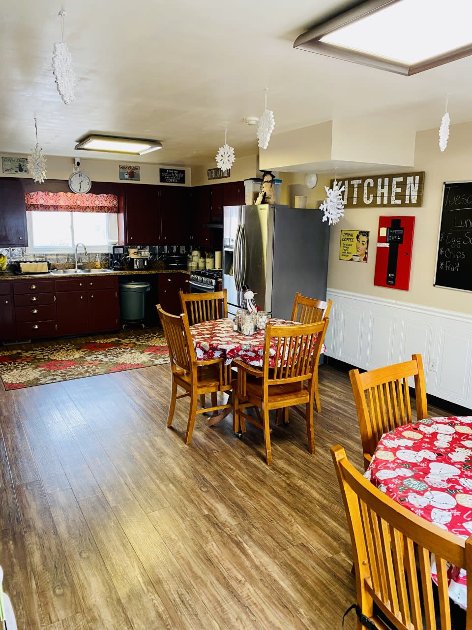 A cozy kitchen and dining area with wooden furniture and appliances.