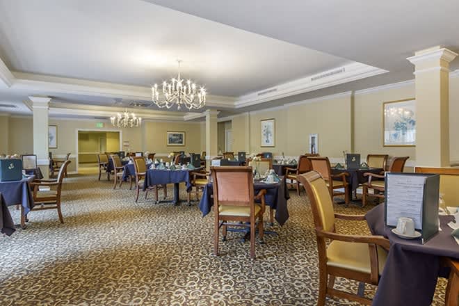 Elegant dining area with chandeliers and classic furniture.