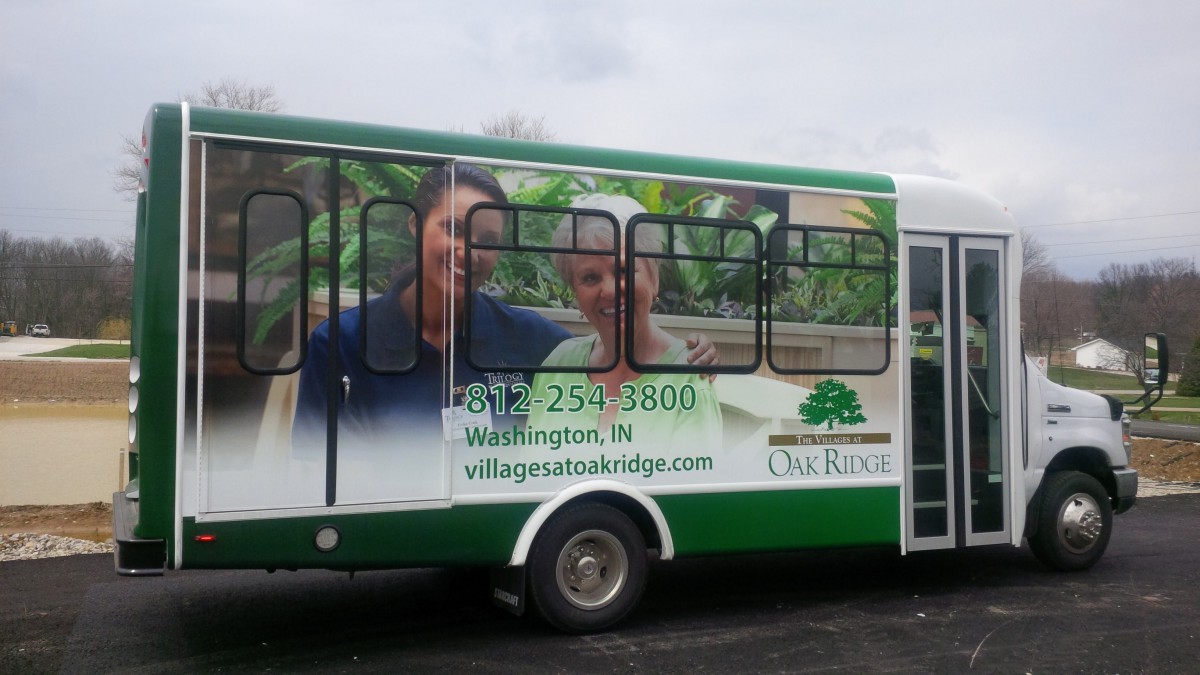 A bus featuring an advertisement for a senior living community.