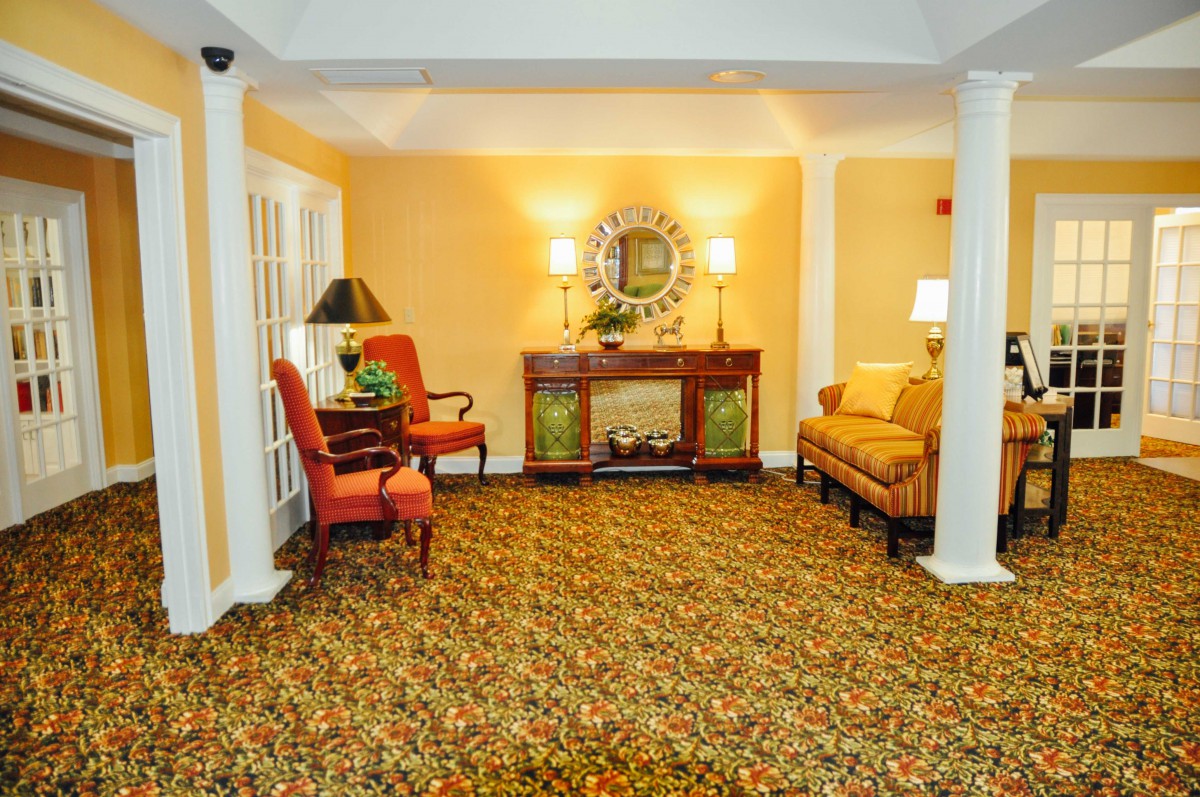 A cozy living room with warm lighting, featuring elegant furniture and decor.
