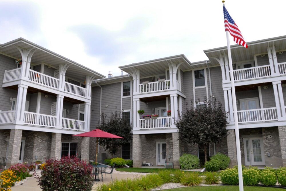 A modern apartment building with balconies and a well-maintained garden.