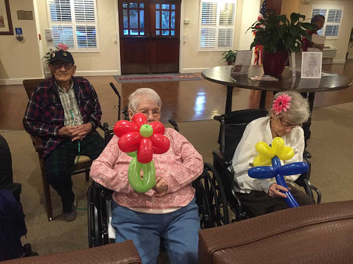 Residents enjoying a balloon art activity, showcasing their colorful creations.