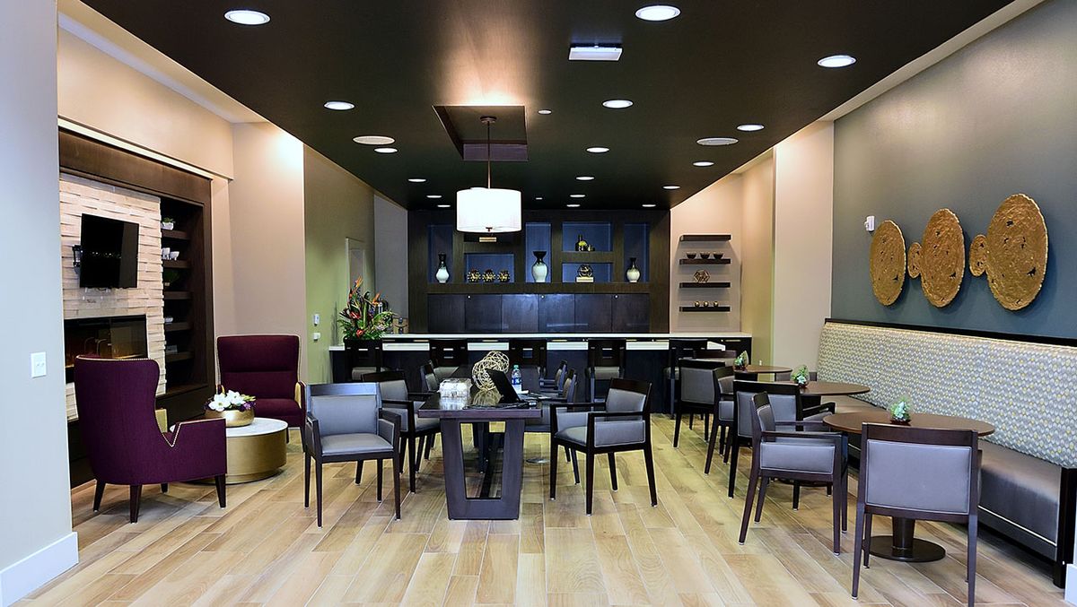 A modern lounge area with stylish seating and a bar setup.
