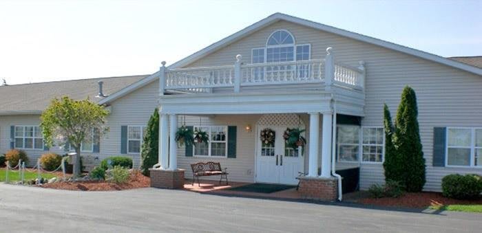 A two-story building with a welcoming entrance and decorative balcony.