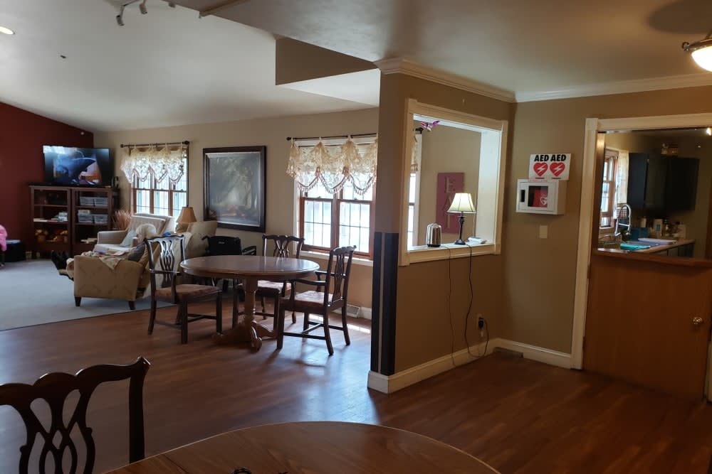 A cozy dining and living area with wood flooring and ample natural light.
