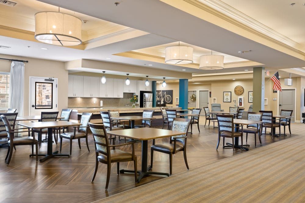 A modern dining area with neatly arranged tables and chairs in a spacious, well-lit setting.