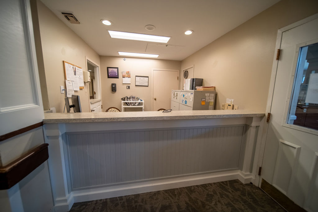 A quiet reception area featuring a desk and office interior.
