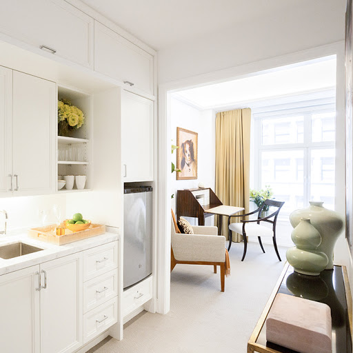 A bright and modern kitchen seamlessly connected to a cozy living area, showcasing minimalist design elements.