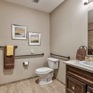 A modern bathroom with a toilet, sink, and stylish decor.