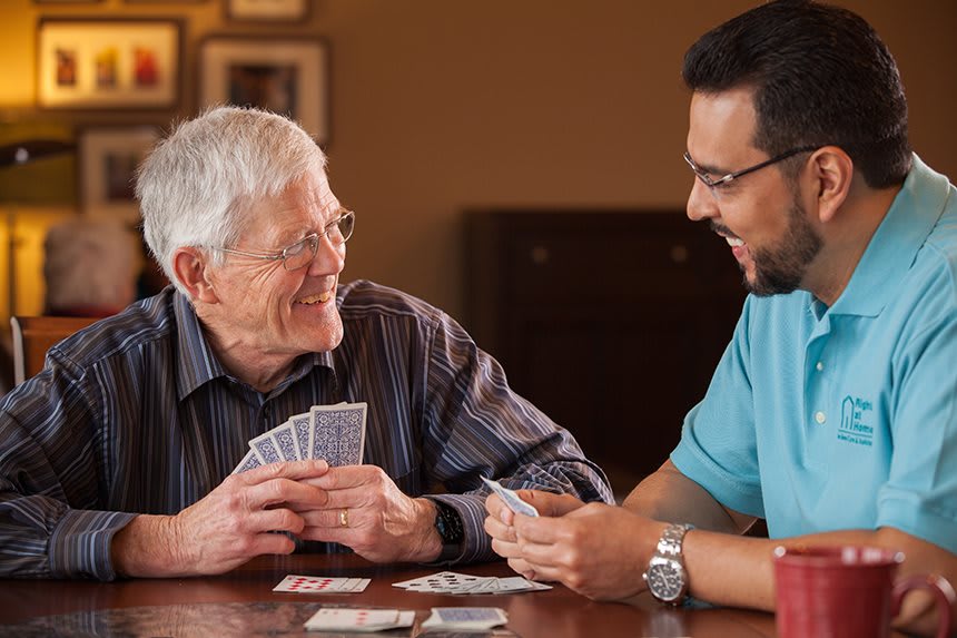 Two people enjoying a card game together indoors.