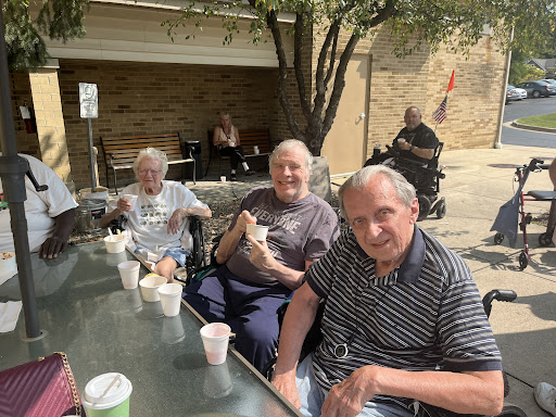 A sunny day spent outdoors with seniors enjoying their snacks and each other's company.