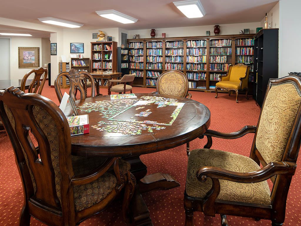 A cozy library with comfortable seating and shelves full of books.