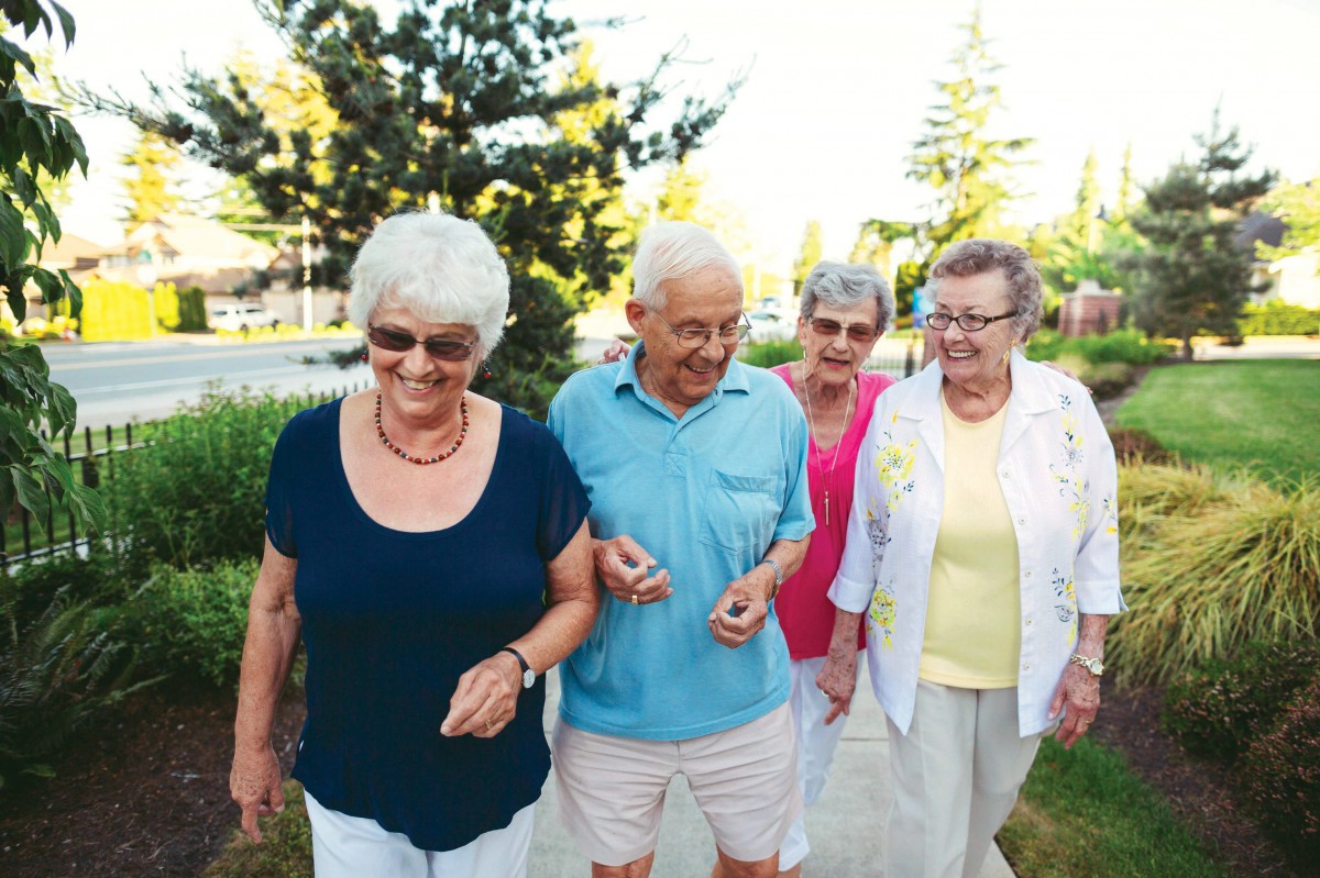 A group of seniors enjoying a walk together outdoors.