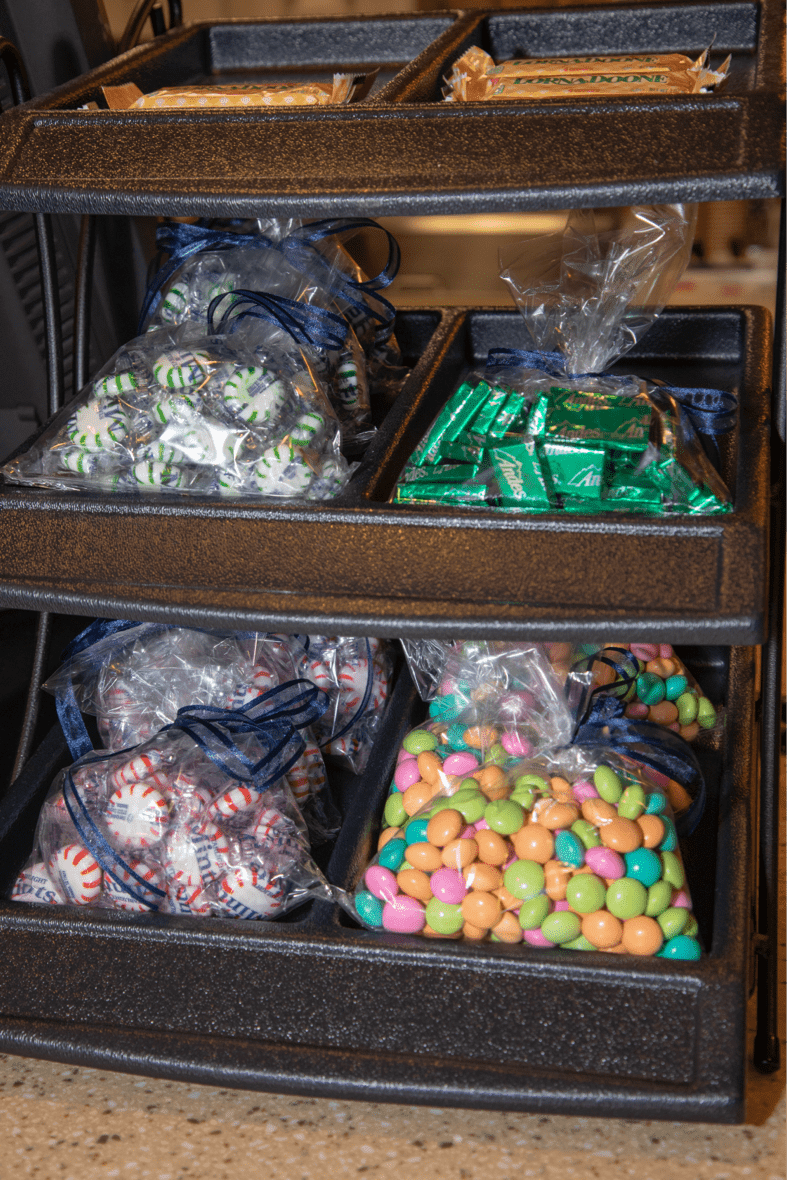 An assortment of packaged mints and colorful candies displayed on shelves.