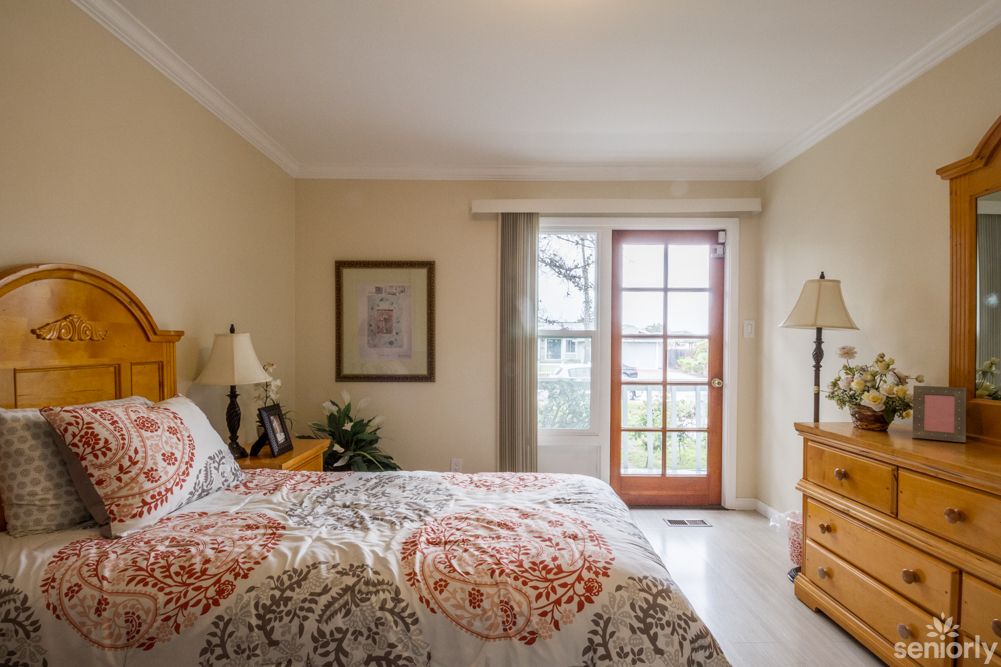 A cozy bedroom with elegant decor and a large window.