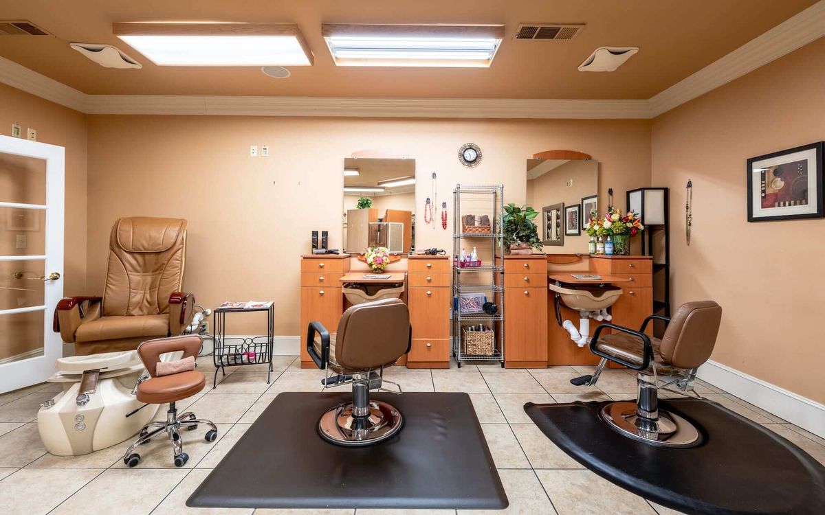 A well-organized hair salon interior featuring styling chairs and mirrors.