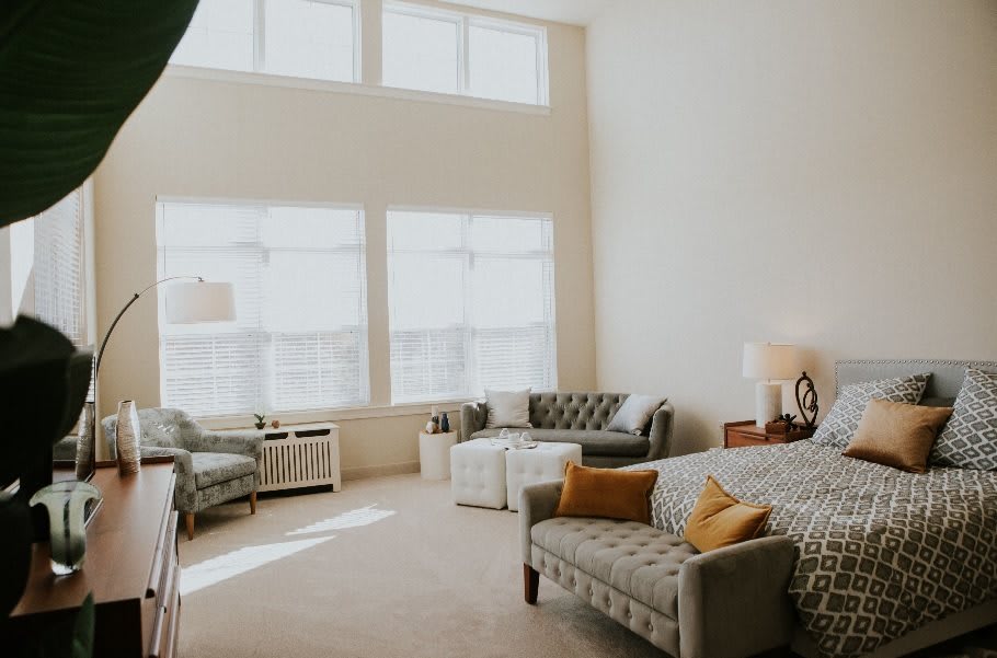 A bright and spacious living room with modern furniture and large windows.
