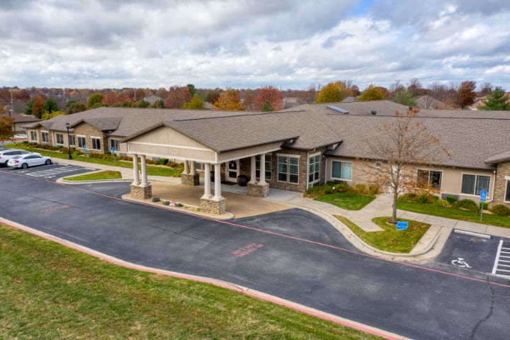 Aerial view of a healthcare facility with a landscaped driveway.