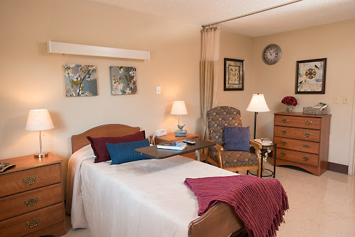 A cozy bedroom featuring warm colors and comfortable furnishings.
