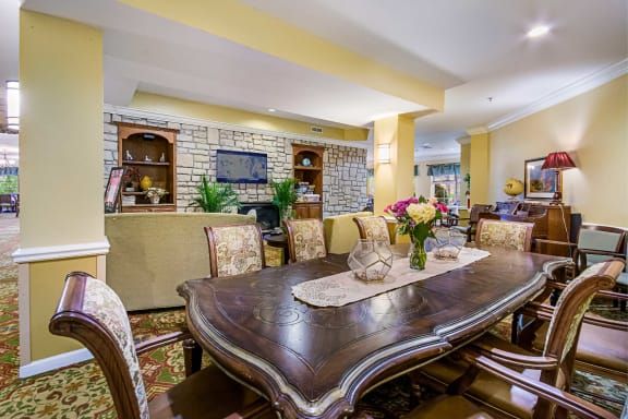 A beautifully decorated dining room featuring an elegant wooden table and upholstered chairs.