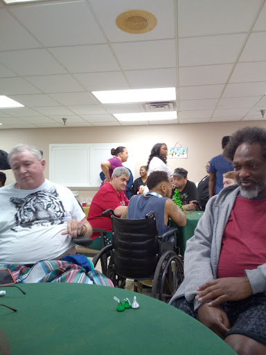 A lively gathering at a community center where individuals are engaging in group activities.