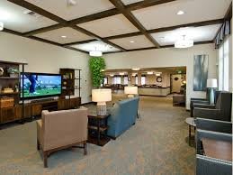 A well-furnished lobby with comfortable seating and a television.