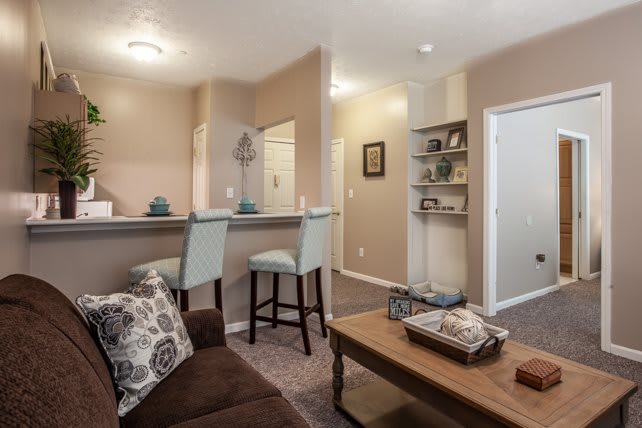 A cozy modern living room with a bar area and stylish furnishings.