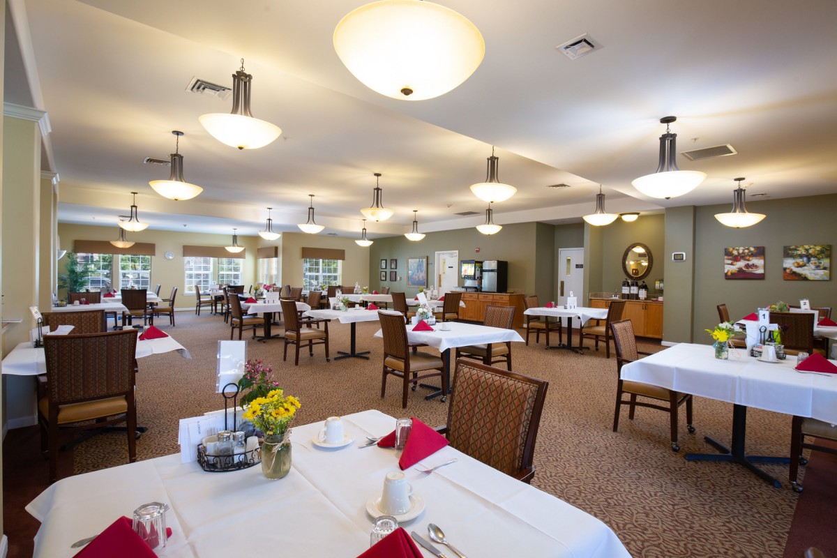A spacious and well-lit dining area with tables set for service.
