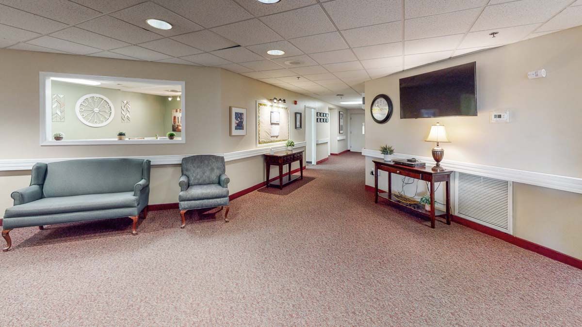 A spacious lobby area with comfortable chairs and a reception desk.