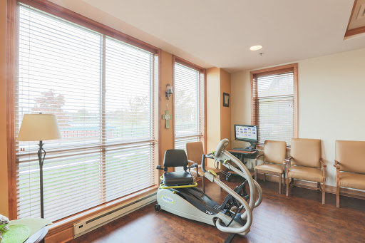 A bright and modern home gym featuring exercise equipment and comfortable seating.
