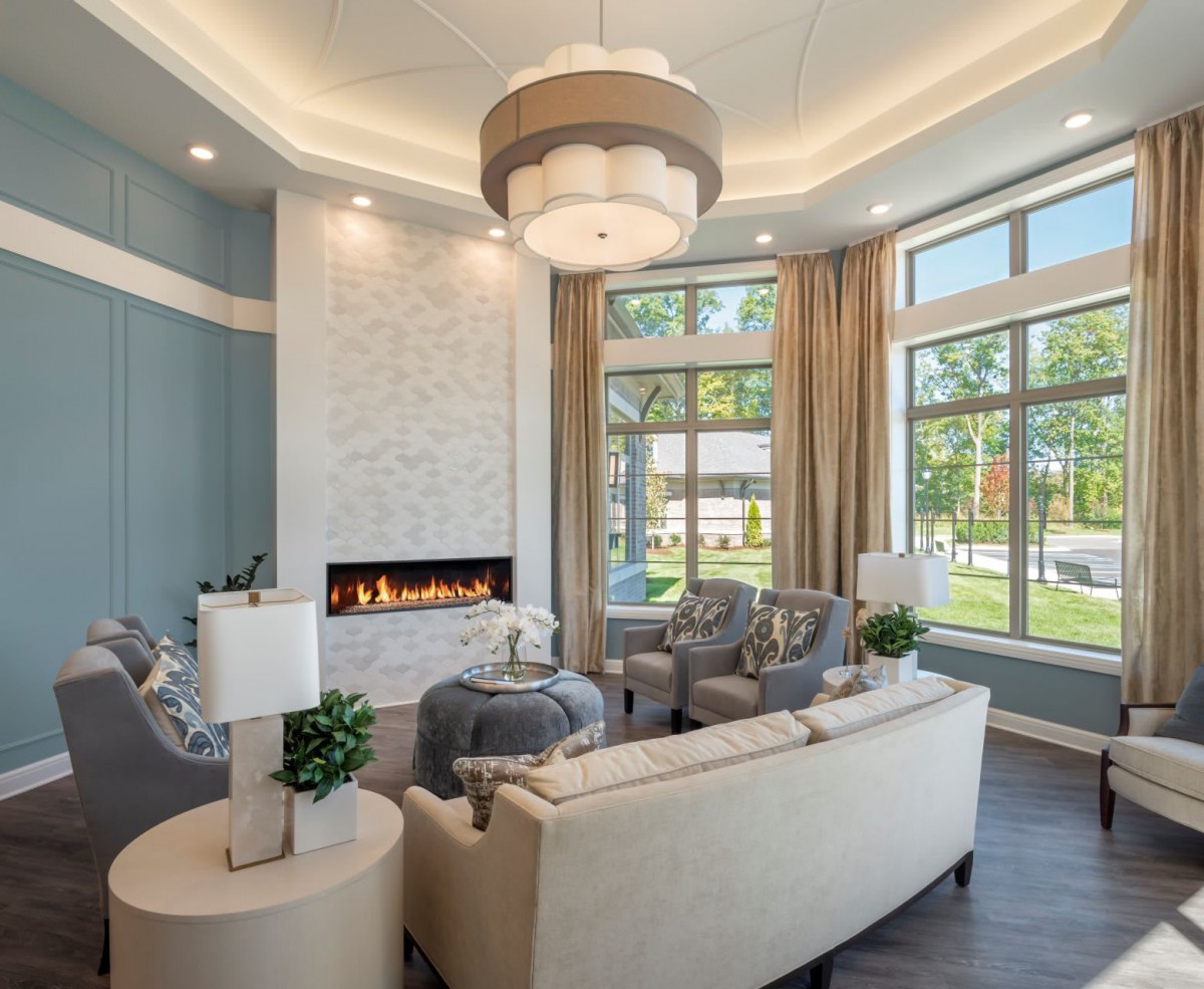 A modern living room with elegant furniture and a cozy fireplace.