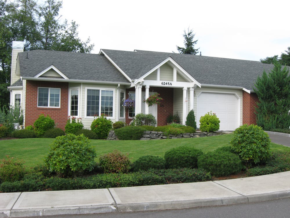 A suburban house with a well-maintained front yard and landscaping.
