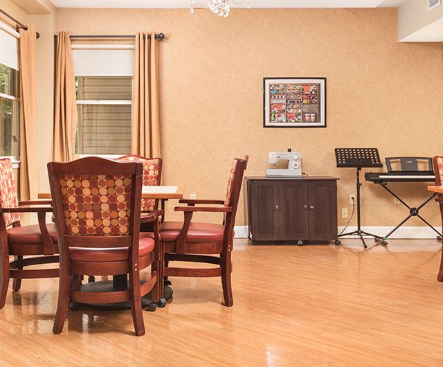 A cozy dining room with wooden furniture and musical instruments.