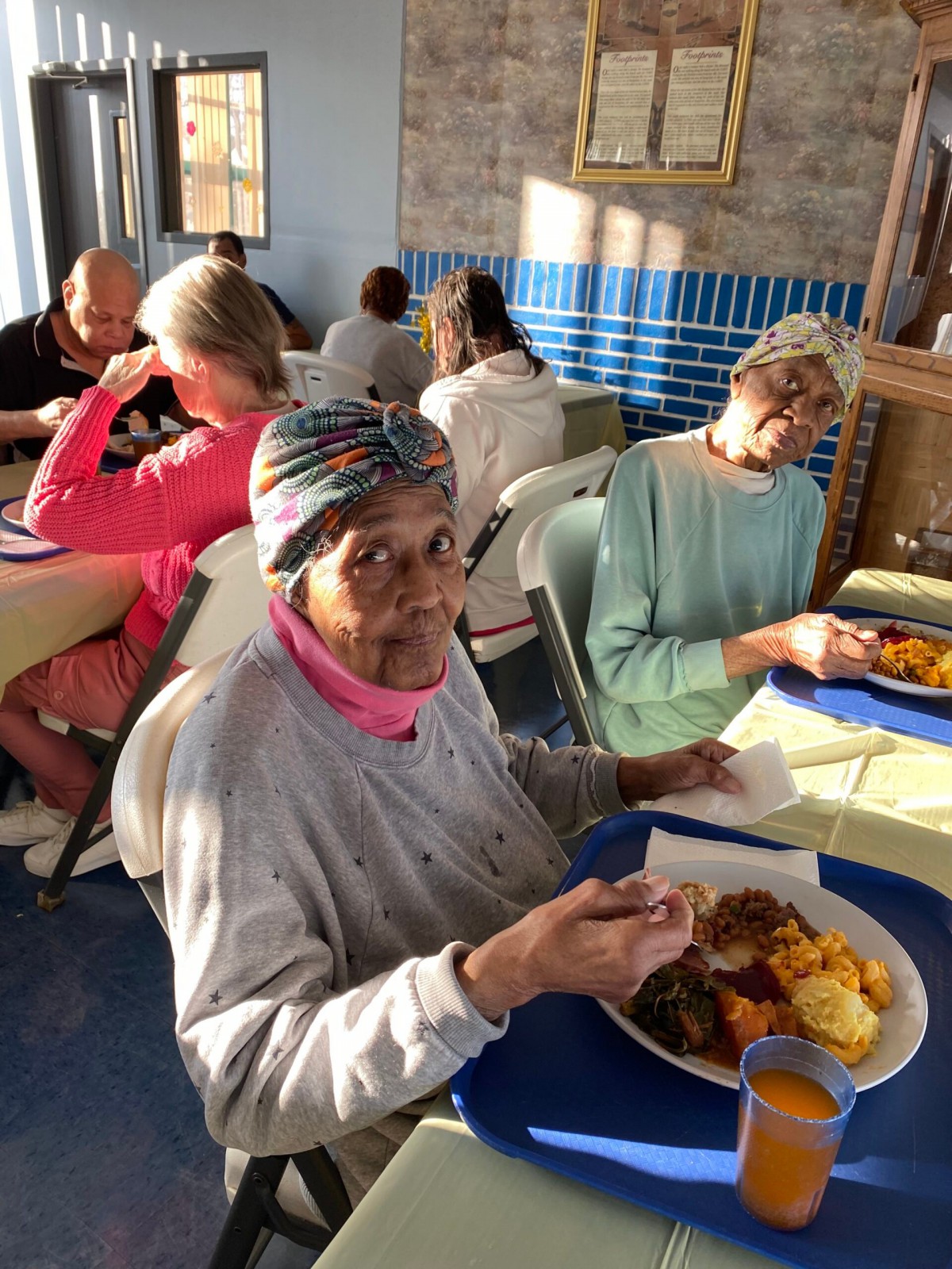 Seniors enjoying a meal together in a community dining setting.
